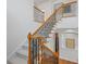 Elegant staircase with wood railing and wrought iron spindles leading to the second floor at 5816 Riverstone Cir # 11, Atlanta, GA 30339