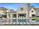 Expansive backyard with pool, covered patio, fire pit and well-maintained lawn at 100 Tuxedo Nw Ter, Atlanta, GA 30342