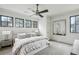 This bedroom features an outside view, neutral colors, and a ceiling fan at 100 Tuxedo Nw Ter, Atlanta, GA 30342