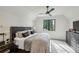 This primary bedroom features a ceiling fan, neutral color scheme, and great natural light from the window at 100 Tuxedo Nw Ter, Atlanta, GA 30342