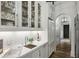 Well-appointed butler's pantry with a stainless steel sink, wine glass storage, and built-in refrigerator at 100 Tuxedo Nw Ter, Atlanta, GA 30342