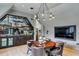 Dining area offering a unique light fixture, wood flooring, built-in bar, and comfortable seating at 100 Tuxedo Nw Ter, Atlanta, GA 30342