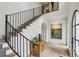 Grand foyer showcasing a staircase with iron railings and hardwood floors, bathed in natural light at 100 Tuxedo Nw Ter, Atlanta, GA 30342