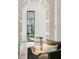 Hallway featuring a decorative archway, hardwood floors, and natural light at 100 Tuxedo Nw Ter, Atlanta, GA 30342