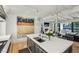 Modern kitchen with large island, stainless steel appliances, and adjacent living area at 100 Tuxedo Nw Ter, Atlanta, GA 30342