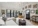 Sunlit living room with hardwood floors, stylish furnishings, and French doors to the pool at 100 Tuxedo Nw Ter, Atlanta, GA 30342