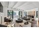 Bright, open-concept living room with fireplace, beamed ceilings, and access to outdoor patio at 100 Tuxedo Nw Ter, Atlanta, GA 30342