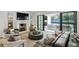 Bright living room with fireplace, ample seating, and glass doors to backyard at 100 Tuxedo Nw Ter, Atlanta, GA 30342