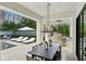 Inviting covered outdoor kitchen and dining area with stainless steel grill and adjacent pool at 100 Tuxedo Nw Ter, Atlanta, GA 30342