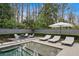Relaxing pool area featuring lounge chairs, an umbrella, and a cozy seating area at 100 Tuxedo Nw Ter, Atlanta, GA 30342