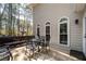 Outdoor dining on the wooden back deck outside of the home with arched windows and siding at 1394 Meadow Springs Dr, Lilburn, GA 30047