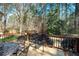 Relaxing back deck featuring elegant black metal patio furniture and a scenic wooded view at 1394 Meadow Springs Dr, Lilburn, GA 30047