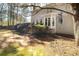 Spacious backyard featuring lush greenery, trees, and charming exterior with a bay window at 1394 Meadow Springs Dr, Lilburn, GA 30047