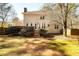 Large backyard with well-maintained lawn, inviting deck, and home's rear elevation at 1394 Meadow Springs Dr, Lilburn, GA 30047