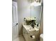 Cozy bathroom featuring neutral tones, a well-lit vanity, and elegant floral arrangements at 1394 Meadow Springs Dr, Lilburn, GA 30047