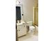 Bathroom featuring a toilet next to the sink and a shower with a gold-framed door at 1394 Meadow Springs Dr, Lilburn, GA 30047