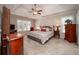 Spacious bedroom with tray ceilings, large windows, and stylish furnishings at 1394 Meadow Springs Dr, Lilburn, GA 30047
