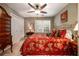 Comfortable bedroom featuring a large closet, ceiling fan, and window for natural light at 1394 Meadow Springs Dr, Lilburn, GA 30047