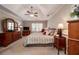 Bedroom featuring a ceiling fan and many wooden dressers with a bed centered around the room at 1394 Meadow Springs Dr, Lilburn, GA 30047