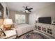 A cozy bedroom offers a ceiling fan, a comfortable bed, and an entertainment center at 1394 Meadow Springs Dr, Lilburn, GA 30047