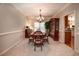 Classic dining area with a wooden table, chandelier, and connection to the kitchen at 1394 Meadow Springs Dr, Lilburn, GA 30047