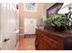 Inviting foyer featuring hardwood floors, a decorative table, and a staircase visible in the background at 1394 Meadow Springs Dr, Lilburn, GA 30047