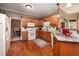 Functional kitchen with wooden cabinetry, granite countertops, and hardwood floors, open to the breakfast area at 1394 Meadow Springs Dr, Lilburn, GA 30047