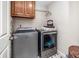 A compact laundry room features modern Maytag washer and dryer set and ample storage cabinet at 1394 Meadow Springs Dr, Lilburn, GA 30047