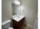 Bathroom featuring a mirror, modern lighting, sink and vanity, and toilet at 1606 Little Creek Dr, Lawrenceville, GA 30045