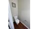 A half bathroom featuring a white toilet and a framed inspirational print at 1606 Little Creek Dr, Lawrenceville, GA 30045