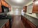 Kitchen with black appliances and dark wood cabinets at 1606 Little Creek Dr, Lawrenceville, GA 30045