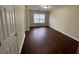 Living room features hardwood floors, neutral paint, and a window providing natural light at 1606 Little Creek Dr, Lawrenceville, GA 30045