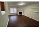 Inviting living room features hardwood floors, a fireplace, and a bright window at 1606 Little Creek Dr, Lawrenceville, GA 30045