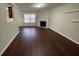 A spacious living room featuring a fireplace, hardwood floors, and natural light at 1606 Little Creek Dr, Lawrenceville, GA 30045