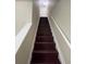 A view of the wood stairway and carpeted steps leading to the upper level of this home at 1606 Little Creek Dr, Lawrenceville, GA 30045