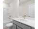 Bright bathroom with a modern vanity, brushed gold hardware, and a shower-tub combo at 1729 Lansmere Sw St, Marietta, GA 30008