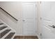 Hallway with wood stairs, dark flooring, and a white interior door at 1729 Lansmere Sw St, Marietta, GA 30008