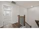 Hallway with wood floors and view into bedroom with neutral carpet and a window at 1729 Lansmere Sw St, Marietta, GA 30008