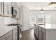 Stylish kitchen with gray cabinets, white countertops, stainless appliances and herringbone backsplash at 1729 Lansmere Sw St, Marietta, GA 30008