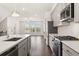 Modern kitchen featuring stainless steel appliances, granite countertops, and an island with a sink at 1729 Lansmere Sw St, Marietta, GA 30008