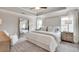 Beautiful main bedroom with tray ceiling, plush carpeting, large mirror, and a sitting chair at 1729 Lansmere Sw St, Marietta, GA 30008