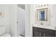 Clean bathroom with black vanity and tiled floors, featuring a shower with curtain at 2528 Fernleaf Nw Ct, Atlanta, GA 30318