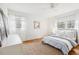 Light-filled bedroom boasts hardwood floors, neutral decor, two windows, and a comfortable queen bed at 2528 Fernleaf Nw Ct, Atlanta, GA 30318