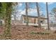 View of modern house with walls of windows, nestled in a beautiful wooded lot at 2528 Fernleaf Nw Ct, Atlanta, GA 30318