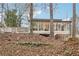 Mid-century modern home with large windows and wood deck at 2528 Fernleaf Nw Ct, Atlanta, GA 30318