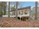 Modern home features large picture windows and a deck overlooking a wooded lot at 2528 Fernleaf Nw Ct, Atlanta, GA 30318