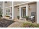 Charming brick home featuring a cozy front porch with rocking chairs and inviting curb appeal at 2528 Fernleaf Nw Ct, Atlanta, GA 30318