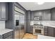 Gray kitchen with stainless steel appliances, including a range, microwave, and refrigerator at 2528 Fernleaf Nw Ct, Atlanta, GA 30318