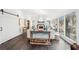 Bright living room with hardwood floors, white walls, sliding barn door, and wooded views at 2528 Fernleaf Nw Ct, Atlanta, GA 30318