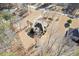 An aerial shot displaying the residence set amongst mature trees on a generously sized lot at 30 Magnolia Dr, Oxford, GA 30054